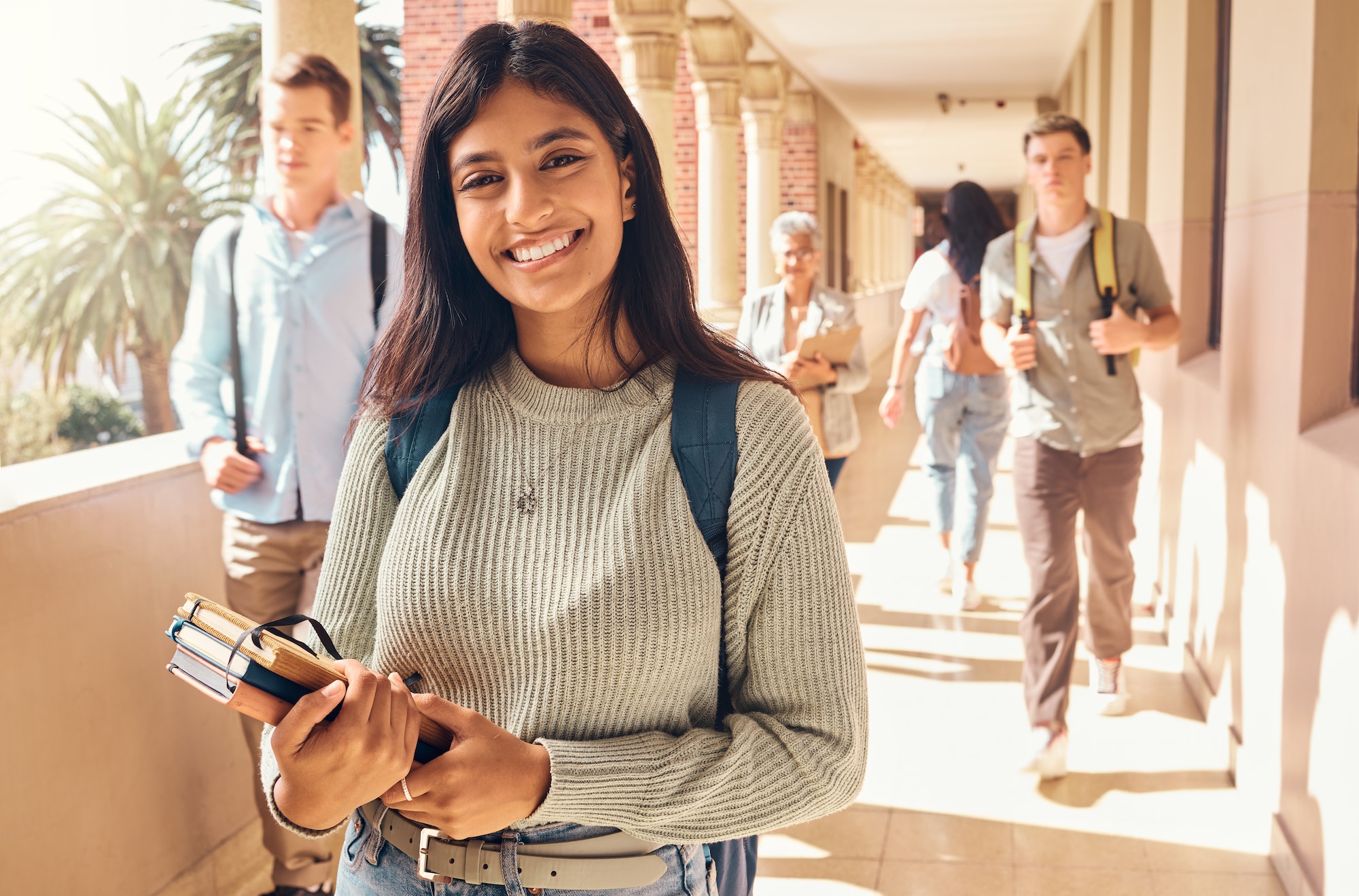 University student, indian woman and portrait at campus outdoor with books of learning, education o